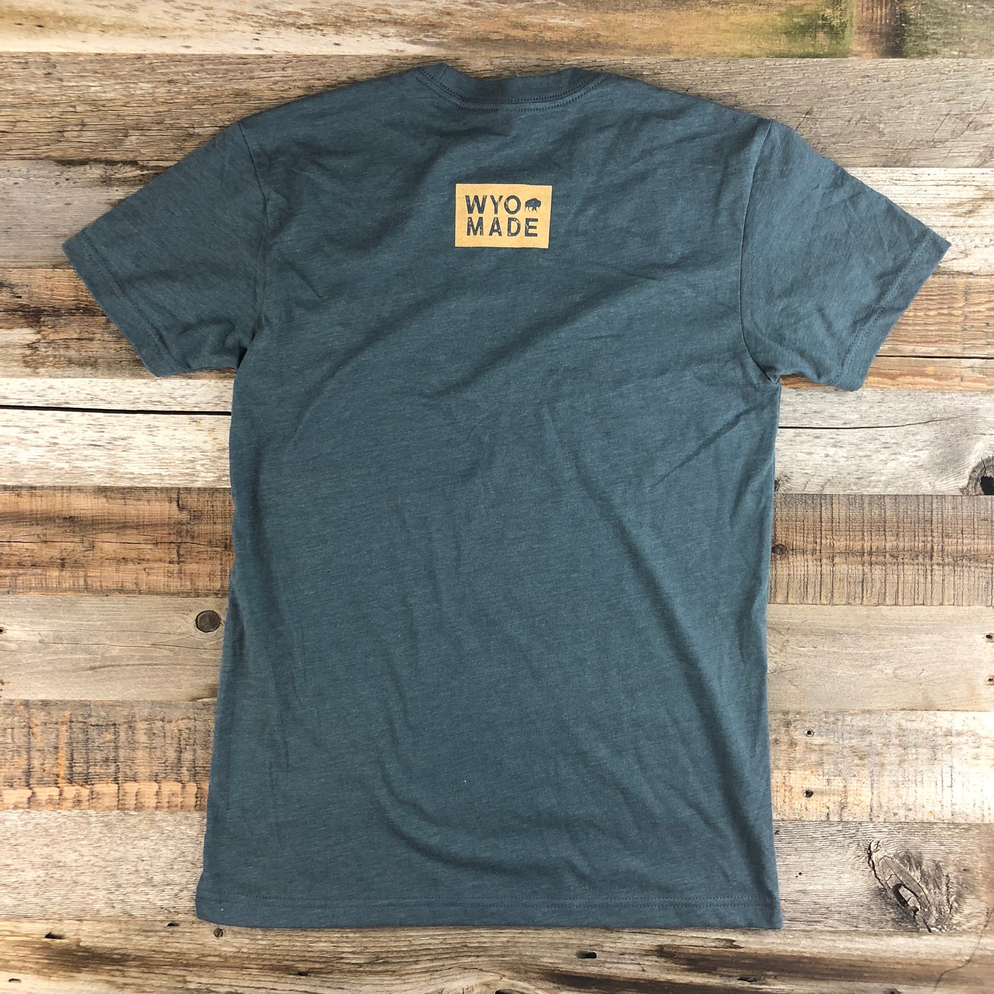 WyoMade Logo Tee | Unisex  The reinvented WyoMade Apparel Logo is a modern twist on our long time iconic design from WyoMade Apparel!   The Bison represents freedom and is a staple of Wyoming's open spaces. This Indigo colored T-shirt is sure to appease your desire to roam free.  Be a part of the herd in a comfy WyoMade Logo T-Shirt deigned for both men and women.  Offering sizes ranging from:  X-Small Small Medium Large Extra Large - XL Double Extra Large - XXL